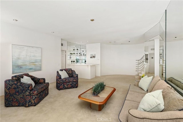 living room with carpet flooring and stairs