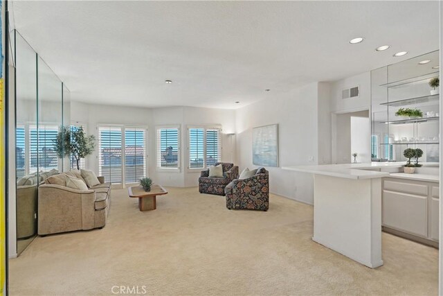living room featuring recessed lighting, visible vents, and light carpet