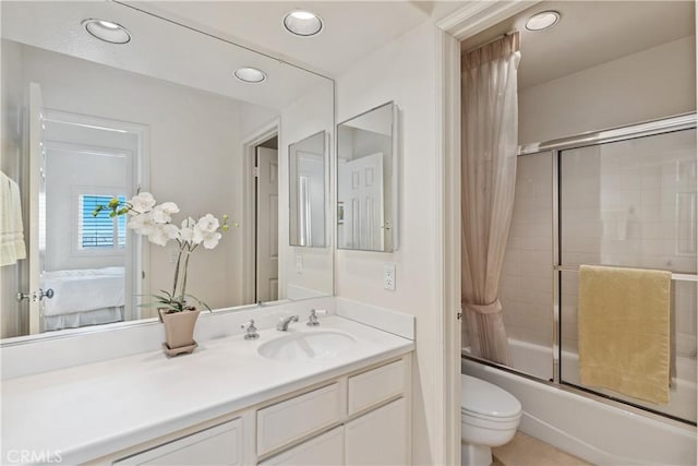 bathroom featuring vanity, toilet, ensuite bathroom, recessed lighting, and bath / shower combo with glass door
