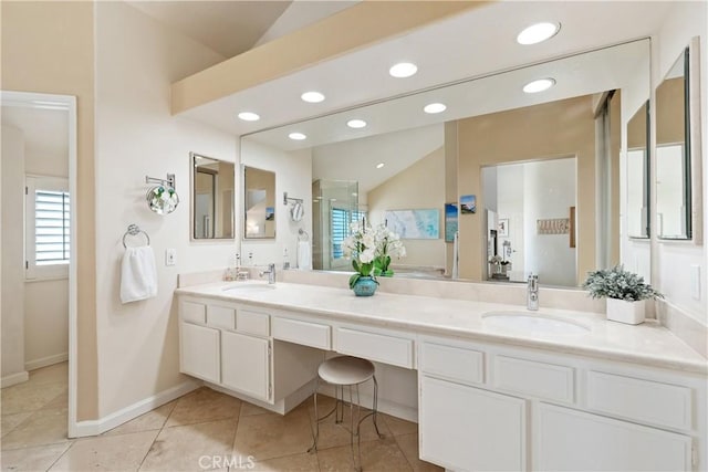 full bath with a sink, a shower stall, recessed lighting, and double vanity