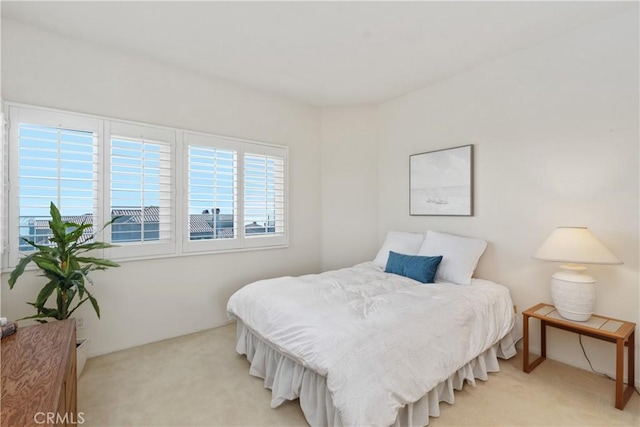 bedroom with light colored carpet