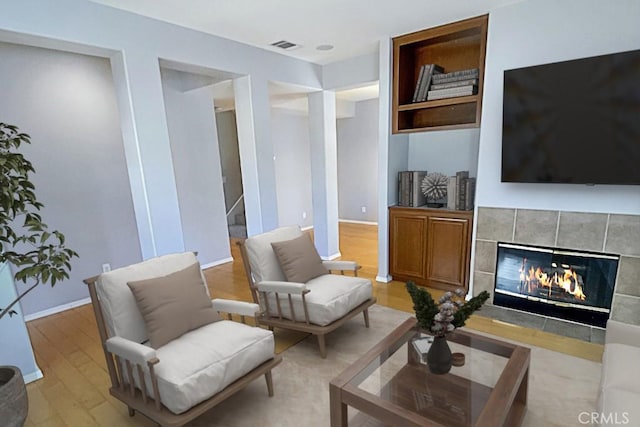 1961 Devaul Ranch Dr, San Luis Obispo, CA 93405 - living area featuring a tile fireplace, light wood-style flooring, baseboards, and stairs