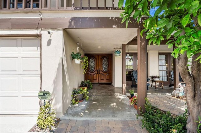 17851 Nearbank Dr, Rowland Heights, CA 91748 - doorway to property featuring stucco siding, covered porch, and a garage