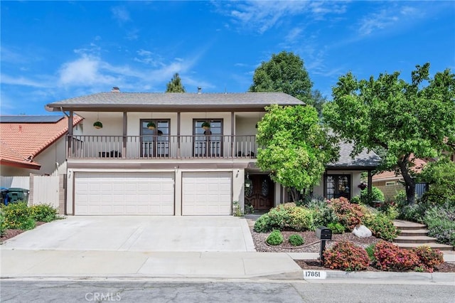 17851 Nearbank Dr, Rowland Heights, CA 91748 - view of front facade with a garage, stucco siding, driveway, and a balcony