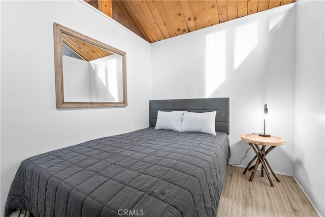 bedroom featuring baseboards, light wood finished floors, and wooden ceiling