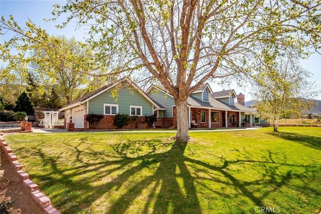 view of front of home with an attached garage, a front lawn, and brick siding
