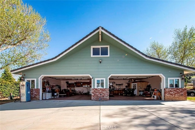 view of side of home with brick siding, gas water heater, and a garage