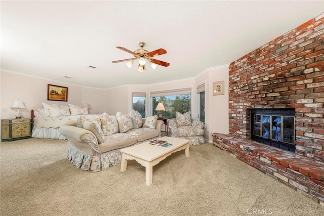 carpeted living area with crown molding, a ceiling fan, and a fireplace