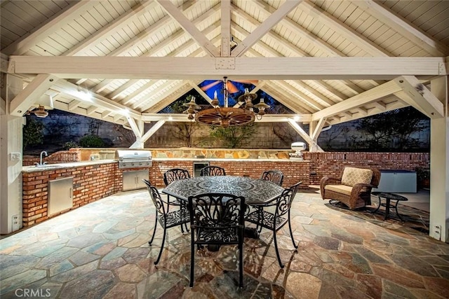 view of patio / terrace with a sink, a gazebo, exterior kitchen, area for grilling, and outdoor dining area