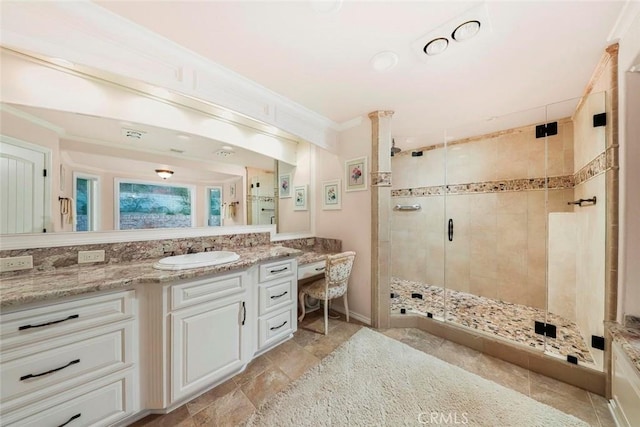 full bathroom featuring a shower stall, vanity, and crown molding