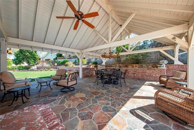 view of patio featuring a gazebo, ceiling fan, outdoor dining space, and an outdoor living space