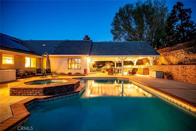 view of pool with a fenced in pool, a patio area, and an in ground hot tub