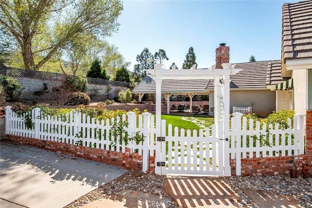 exterior space featuring a pergola and a fenced front yard