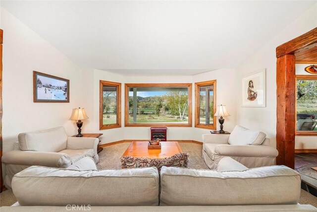 living room featuring carpet floors and baseboards