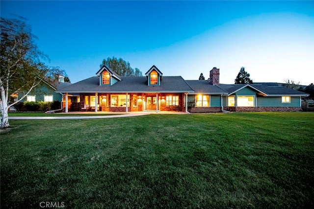 view of front of home with a front yard and a chimney