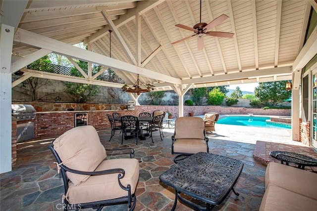 view of patio / terrace with area for grilling, beverage cooler, a gazebo, a fenced in pool, and outdoor dining space