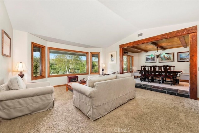 carpeted living room with visible vents, baseboards, and lofted ceiling with beams