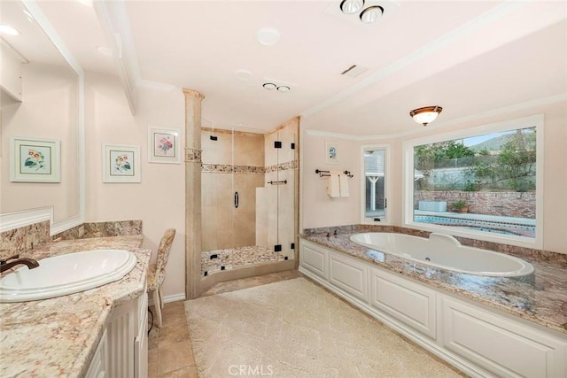 bathroom featuring crown molding, vanity, tile patterned floors, a stall shower, and a garden tub