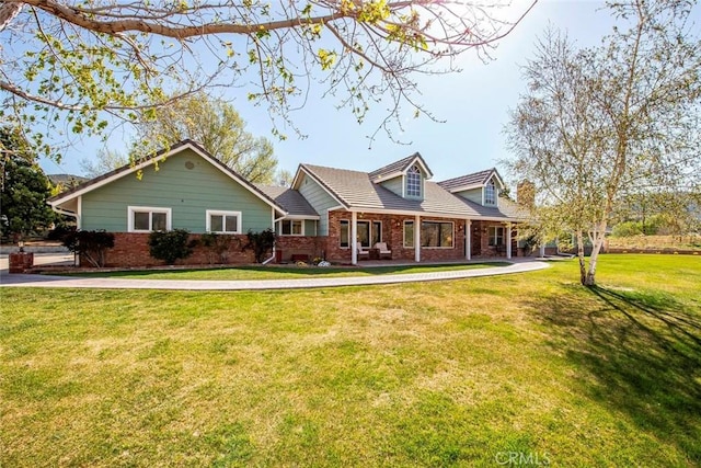 new england style home with brick siding and a front lawn