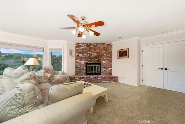 living area with ornamental molding, a ceiling fan, light colored carpet, and visible vents