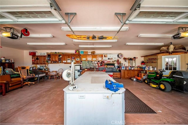 garage with a garage door opener and a workshop area