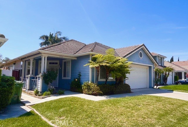11950 Reichling Ln, Whittier, CA 90606 - ranch-style house with an attached garage, driveway, a front yard, and a tile roof