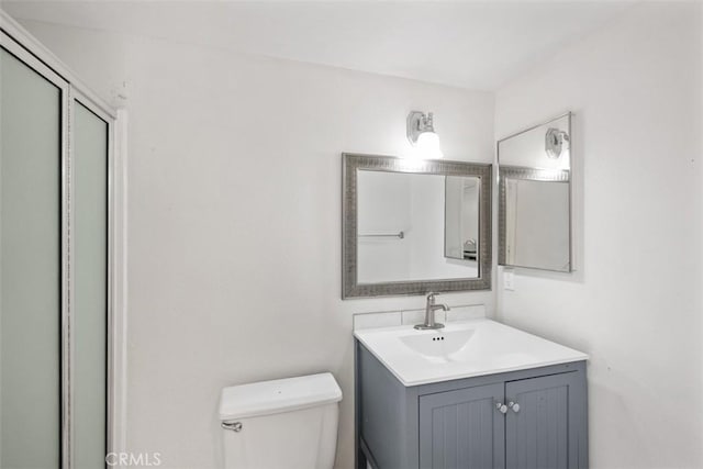 778 La Tierra St Unit H102, Corona, CA 92879 - bathroom with vanity, toilet, and a shower with door