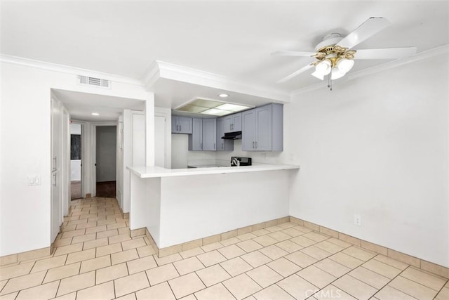 778 La Tierra St Unit H102, Corona, CA 92879 - kitchen with ornamental molding, light countertops, under cabinet range hood, ceiling fan, and a peninsula