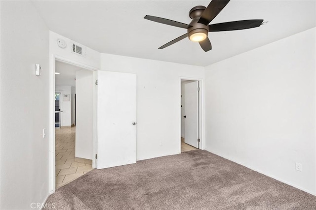 778 La Tierra St Unit H102, Corona, CA 92879 - unfurnished bedroom with carpet flooring and ceiling fan
