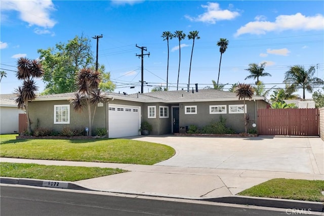 ranch-style home with a front yard, a garage, fence, concrete driveway, and stucco siding