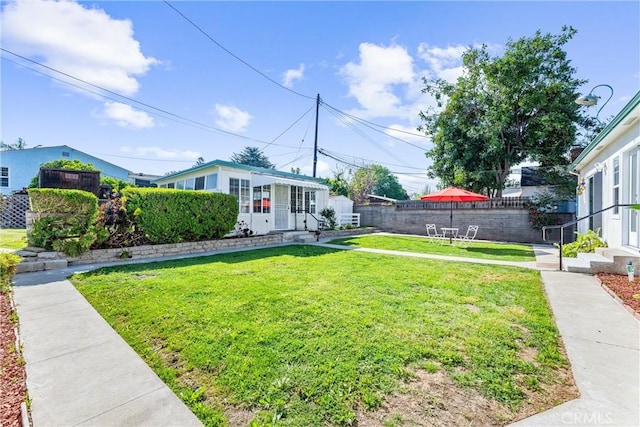 view of yard featuring fence and entry steps
