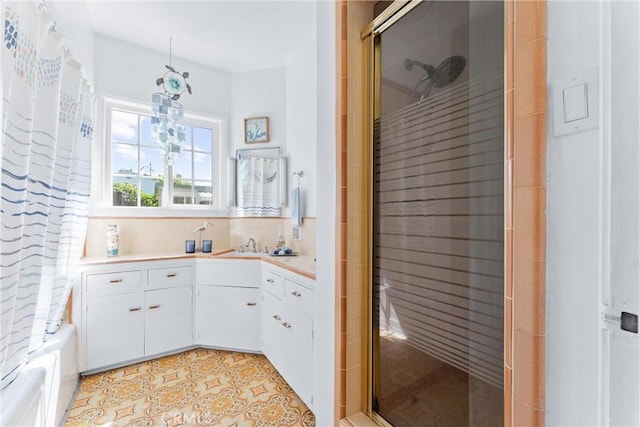 full bathroom featuring a shower stall, tile patterned floors, vanity, and decorative backsplash