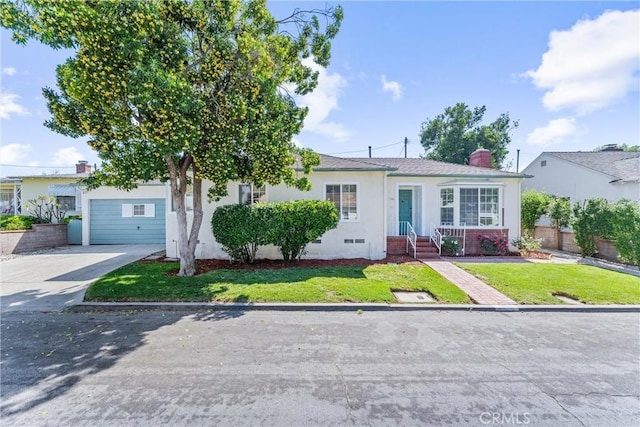 ranch-style home with driveway, a chimney, an attached garage, a front yard, and stucco siding