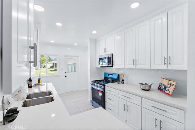 kitchen featuring recessed lighting, stainless steel appliances, baseboards, decorative backsplash, and white cabinetry