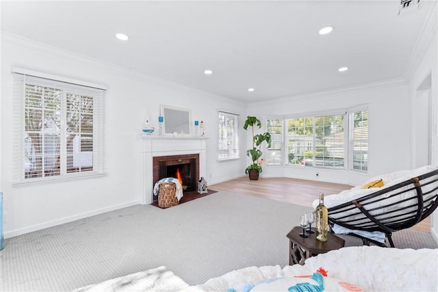 living area with crown molding, a brick fireplace, visible vents, and recessed lighting