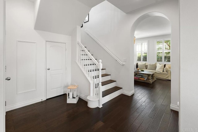 3477 Filoli Cir, Carlsbad, CA 92009 - staircase with hardwood / wood-style floors, arched walkways, and baseboards