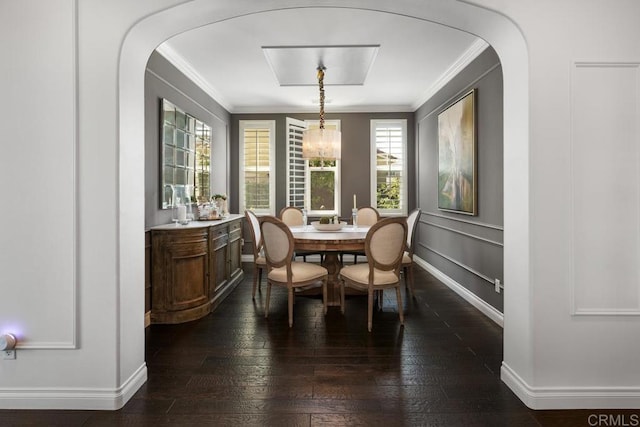 3477 Filoli Cir, Carlsbad, CA 92009 - dining room with arched walkways, ornamental molding, baseboards, dark wood-type flooring, and a chandelier
