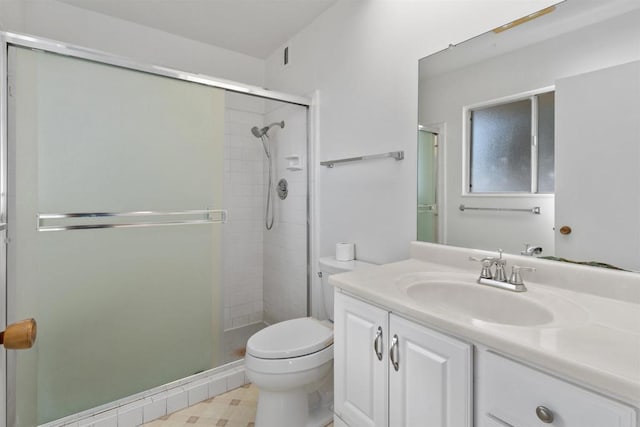 bathroom with a shower stall, vanity, and toilet