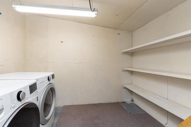 clothes washing area with washer and dryer, laundry area, and carpet floors