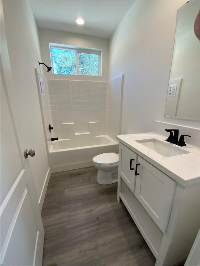 full bathroom featuring bathing tub / shower combination, vanity, recessed lighting, toilet, and wood finished floors