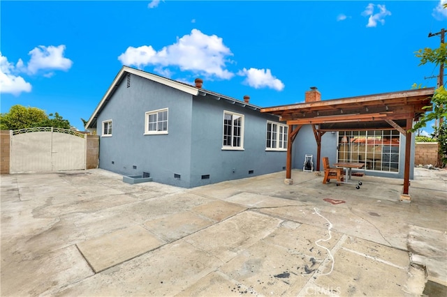 8731 Bel Air St, Buena Park, CA 90620 - back of house with crawl space, a gate, a chimney, a patio area, and stucco siding