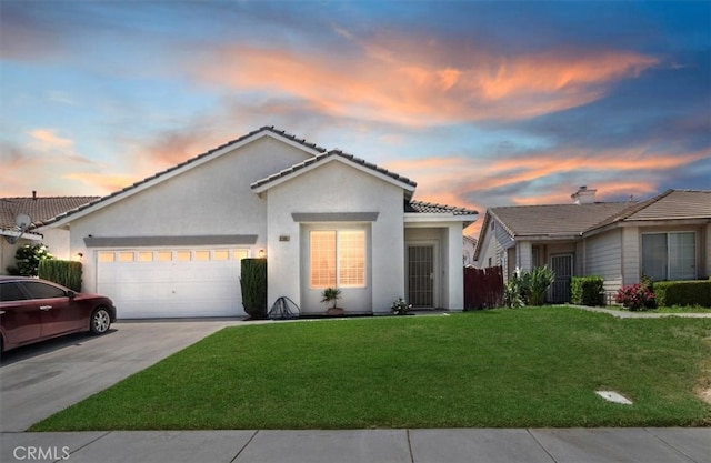 5166 Contay Way, Jurupa Valley, CA 92509 - ranch-style home with an attached garage, a lawn, driveway, stucco siding, and a tile roof