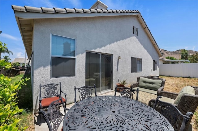 5166 Contay Way, Jurupa Valley, CA 92509 - rear view of house with outdoor dining space, stucco siding, and a patio