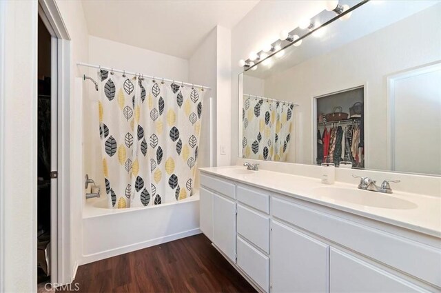 5166 Contay Way, Jurupa Valley, CA 92509 - full bath featuring double vanity, wood finished floors, shower / bathtub combination with curtain, and a walk in closet