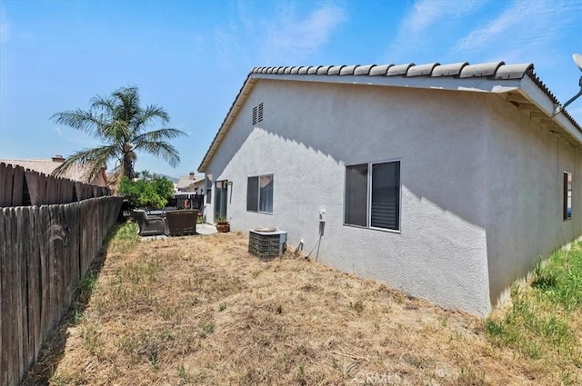 5166 Contay Way, Jurupa Valley, CA 92509 - back of property with a fenced backyard, central AC, and stucco siding