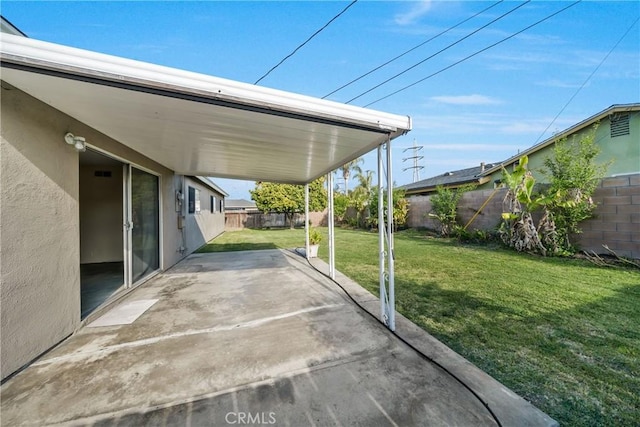view of patio / terrace featuring a fenced backyard and an attached carport