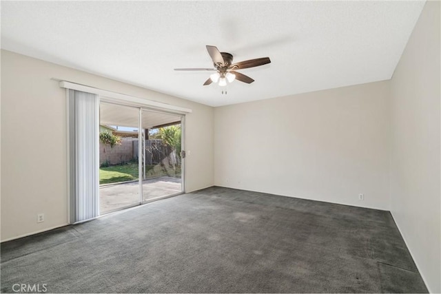 empty room featuring a ceiling fan and carpet floors