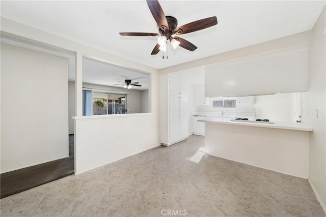unfurnished living room featuring a ceiling fan