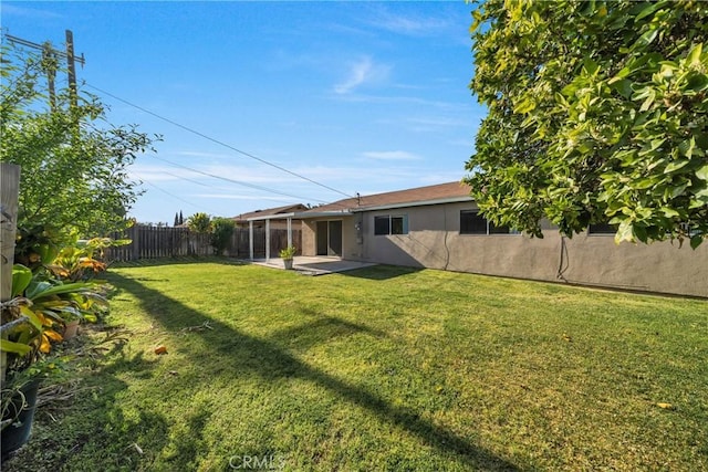 exterior space featuring a patio, stucco siding, a fenced backyard, and a lawn