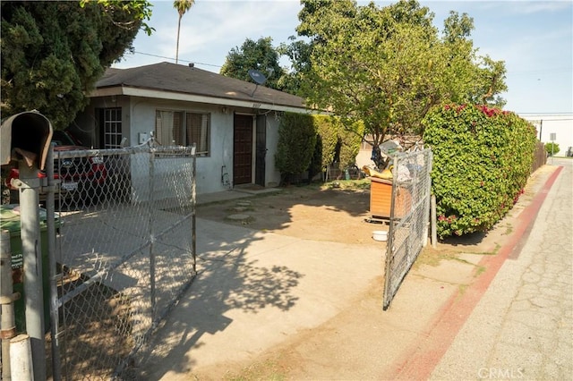 9925 Woodrich Ln, El Monte, CA 91731 - view of side of home featuring stucco siding, fence, and a gate